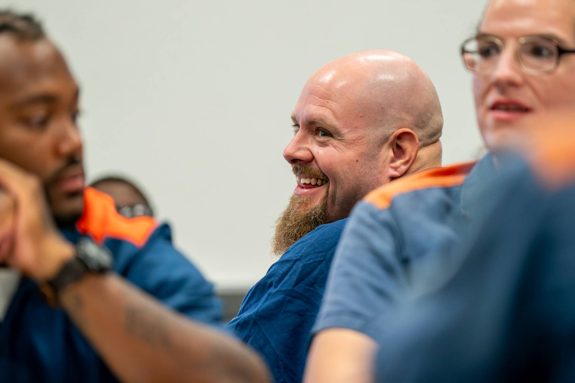 A student in class, smiling.